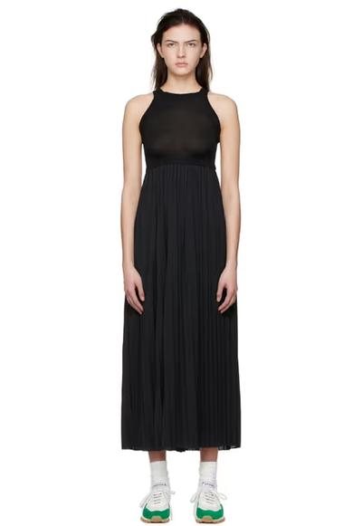 A woman wearing VAARA black polyester midi dress