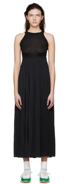 A woman wearing VAARA black polyester midi dress