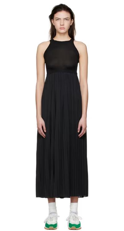 A woman wearing VAARA black polyester midi dress