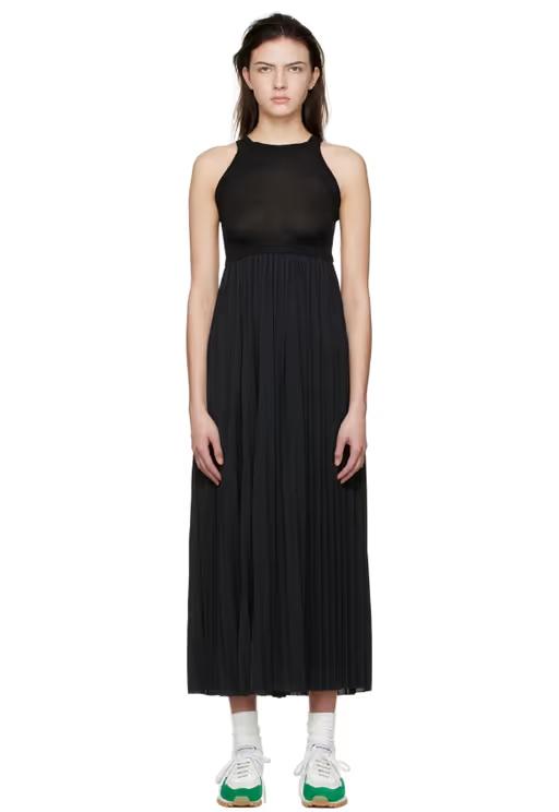 A woman wearing VAARA black polyester midi dress