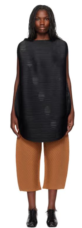 A woman wearing PLEATS PLEASE ISSEY MIYAKE black orbit minidress