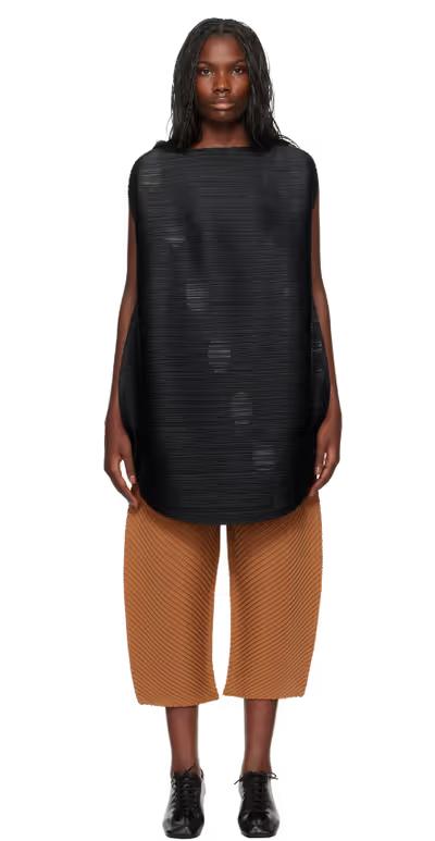 A woman wearing PLEATS PLEASE ISSEY MIYAKE black orbit minidress