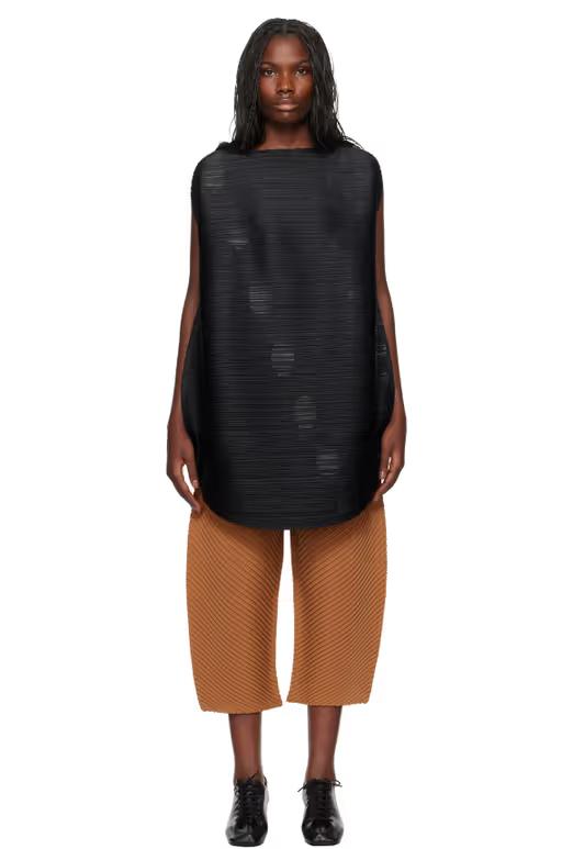 A woman wearing PLEATS PLEASE ISSEY MIYAKE black orbit minidress