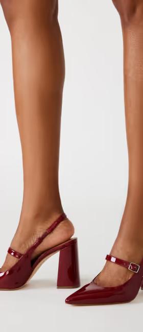 A woman wearing Steve Madden​ maegan wine patent slingbacks