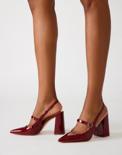 A woman wearing Steve Madden maegan wine patent slingbacks