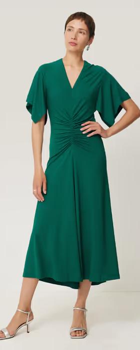 A woman wearing Jigsaw crepe flutter sleeve dress