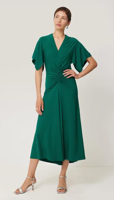 A woman wearing Jigsaw crepe flutter sleeve dress