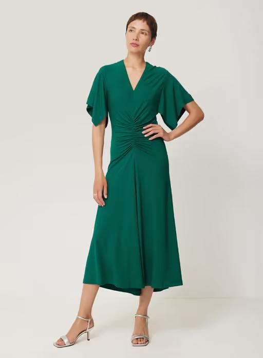 A woman wearing Jigsaw crepe flutter sleeve dress