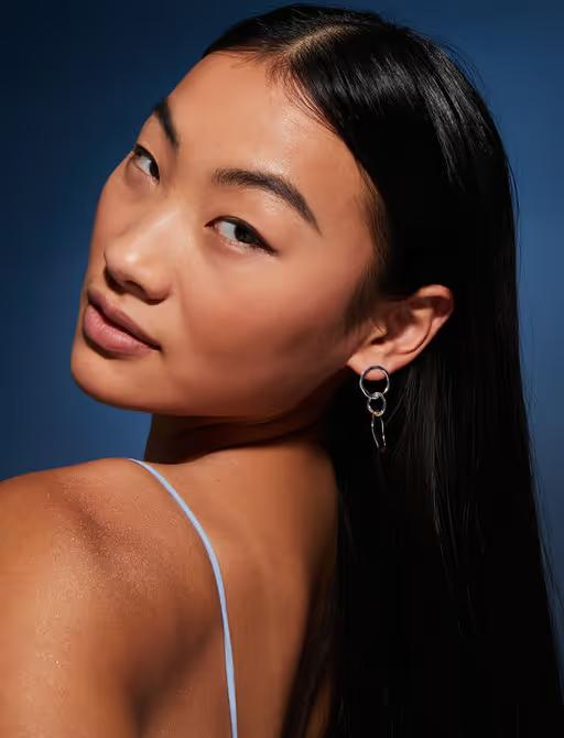 A woman wearing Accessorize sterling silver-plated circle drop earrings