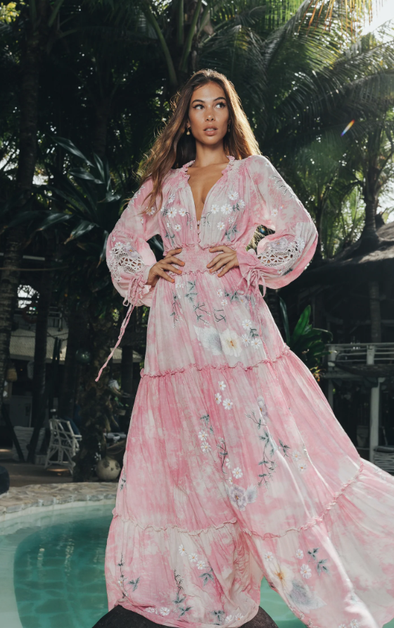 A woman wearing a floral pink Fillyboo dress