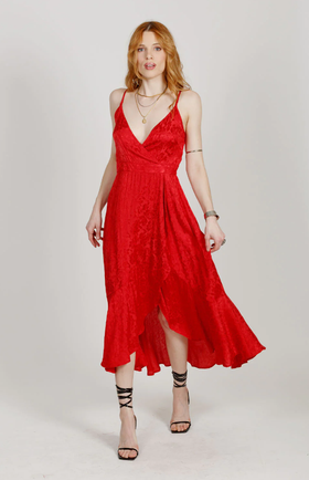 A woman wearing a red Band Of The Free dress and heels