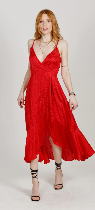 A woman wearing a red Band Of The Free dress and heels
