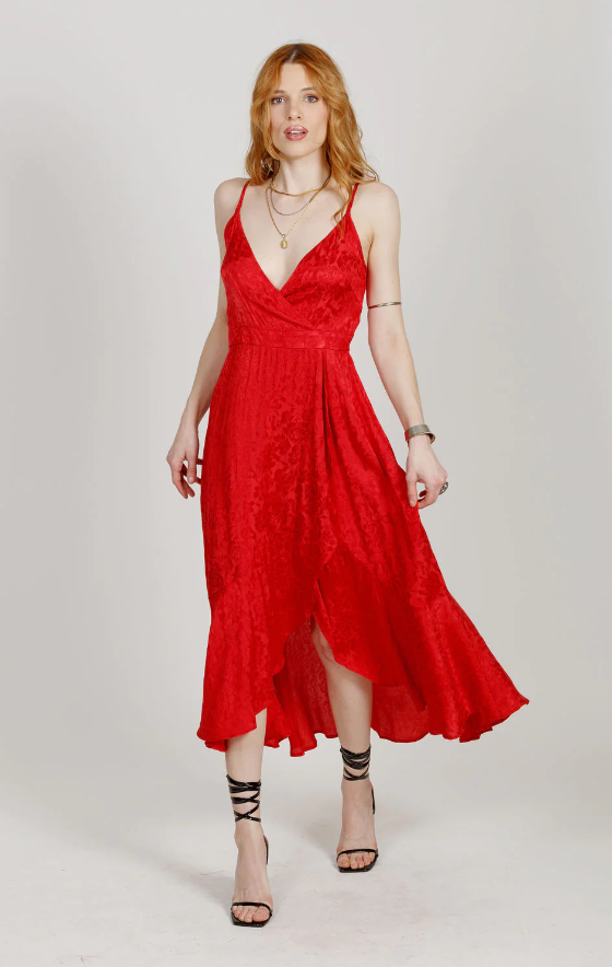 A woman wearing a red Band Of The Free dress and heels
