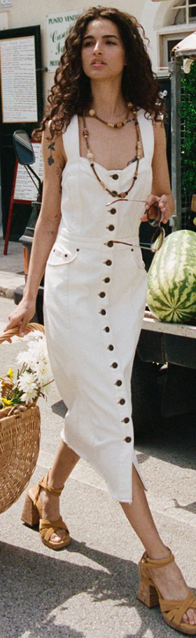 A woman wearing a Spell white dress