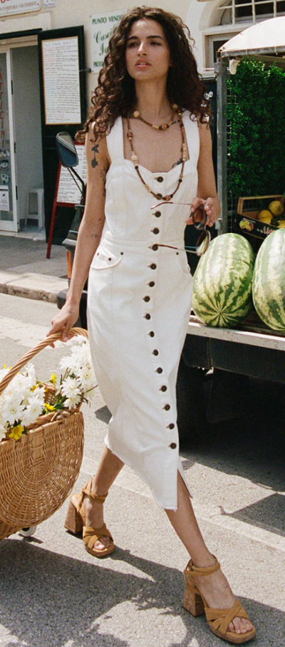 A woman wearing a Spell white dress