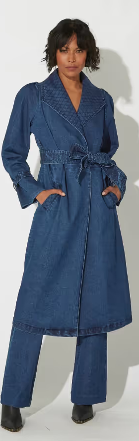 A woman wearing a blue Cleobella suit dress and heels