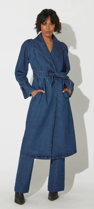 A woman wearing a blue Cleobella suit dress and heels