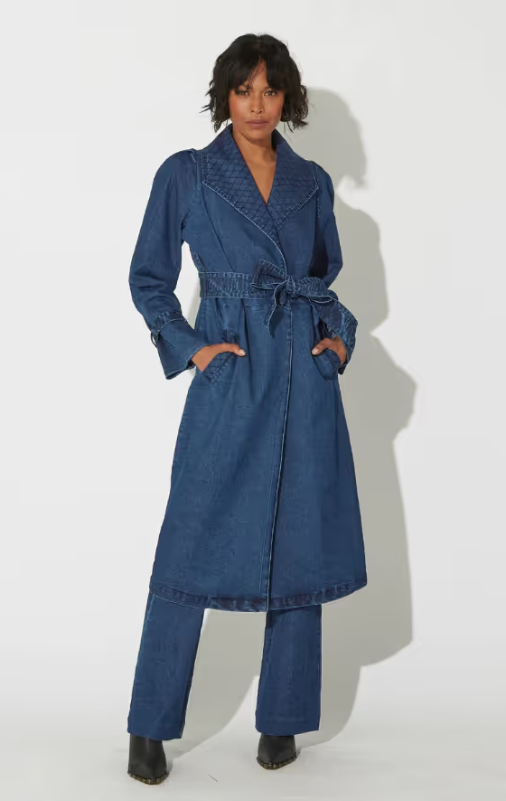 A woman wearing a blue Cleobella suit dress and heels