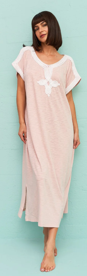 A wiman wearing a light pink Pitusa dress