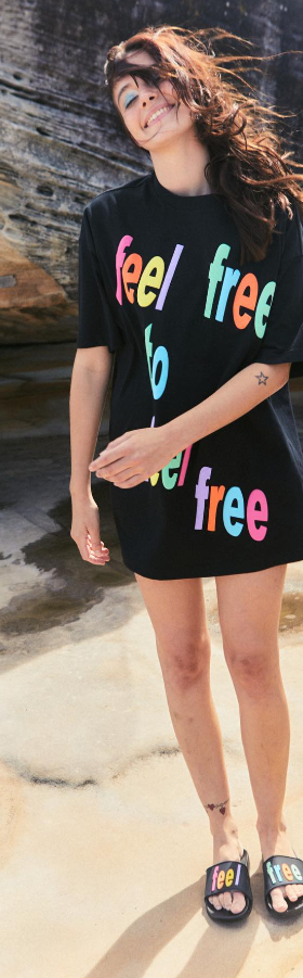A man wearing a black Romance Was Born 'free' t-shirt and matching slides