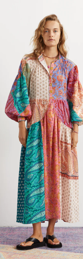 A woman wearing an oversize Boteh colorful dress