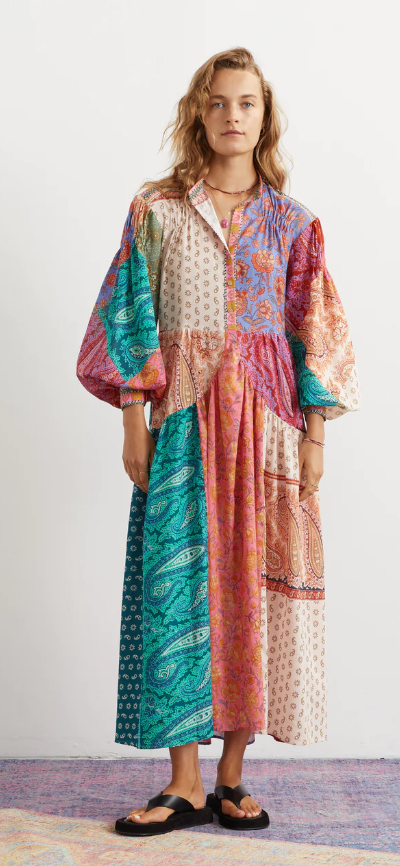 A woman wearing an oversize Boteh colorful dress