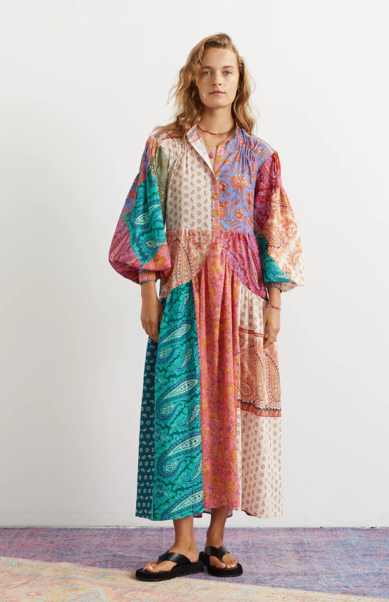 A woman wearing an oversize Boteh colorful dress