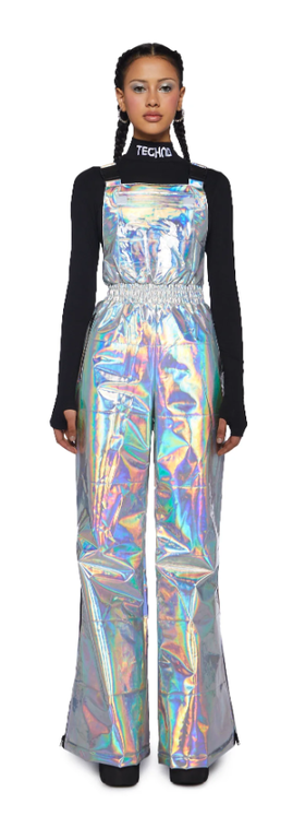A woman wearing a shiny Dolls Kill dress with a black long-sleeve underneath