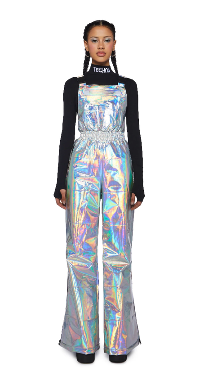 A woman wearing a shiny Dolls Kill dress with a black long-sleeve underneath