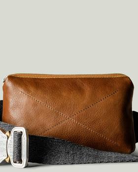 A close-up of a Hard Graft Leather crossover bag