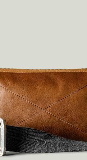 A close-up of a Hard Graft Leather crossover bag