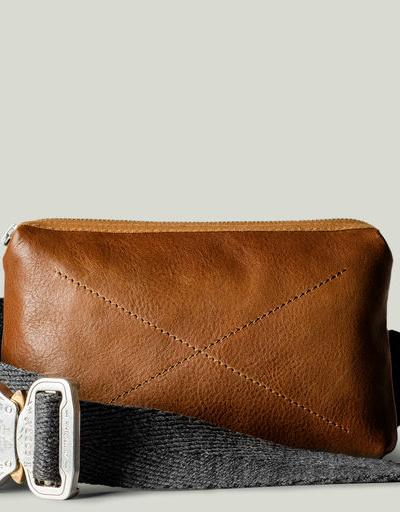 A close-up of a Hard Graft Leather crossover bag