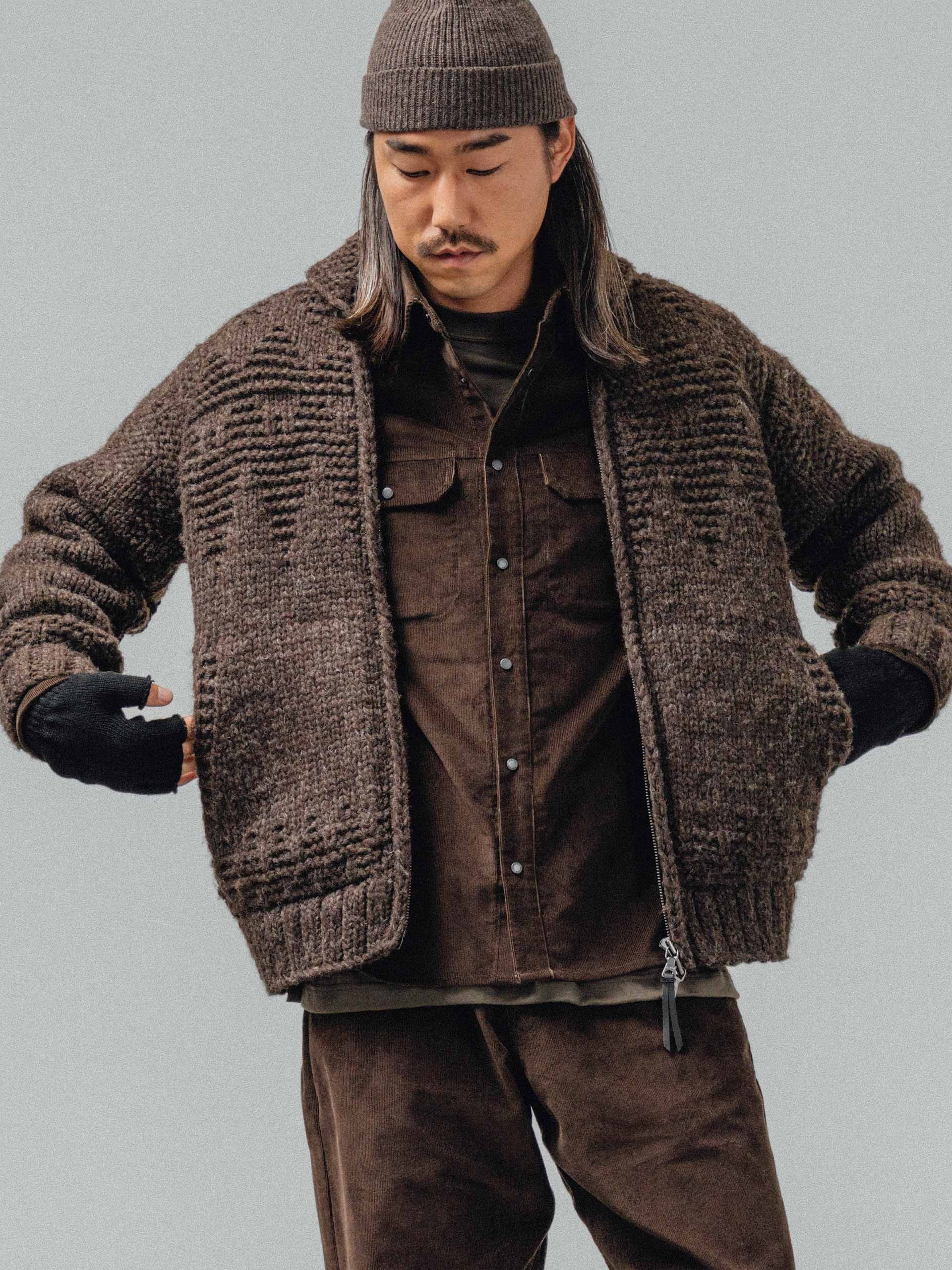 A man in a chunky brown knit cardigan over a corduroy shirt and trousers, from Haven's Fall/Winter 2025 collection