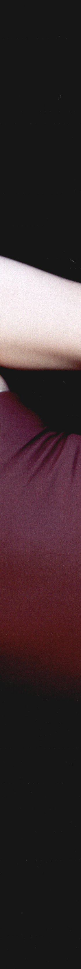 Acacia model wearing a burgundy one-piece swimsuit