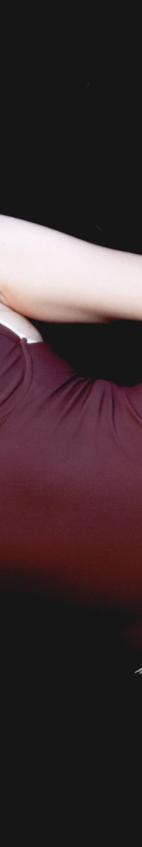 Acacia model wearing a burgundy one-piece swimsuit