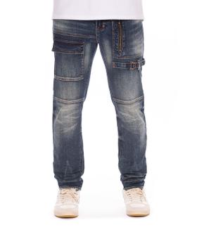 A man wearing dark-wash AKOO utility denim jeans with zip and cargo pockets