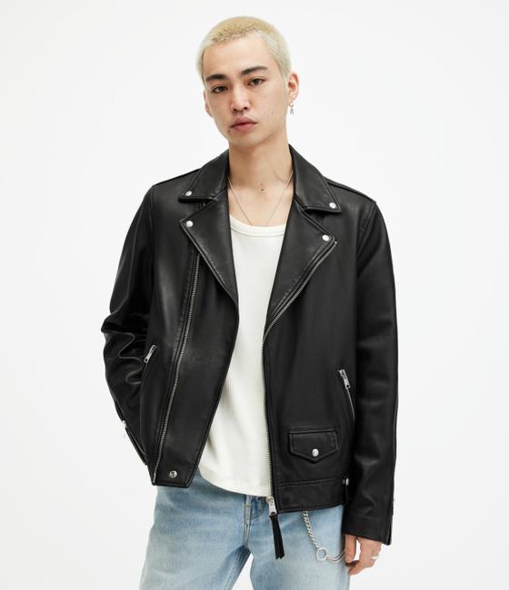 A man in a black AllSaints leather biker jacket over a white tank and light jeans