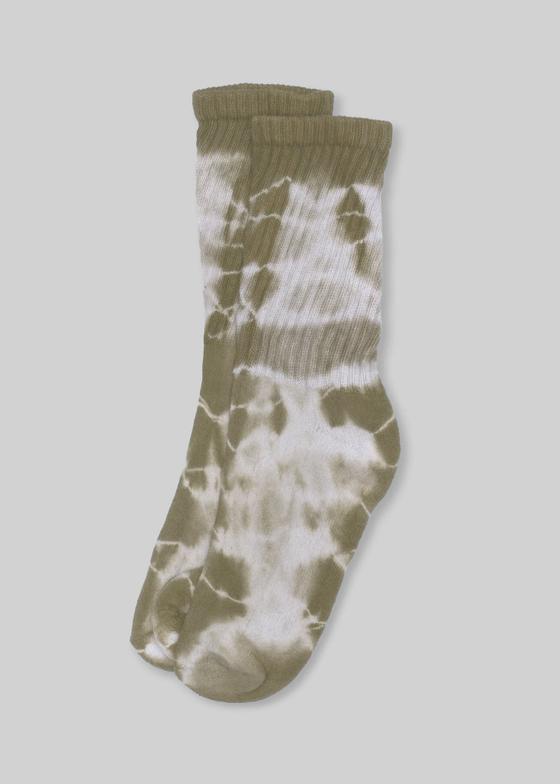 A pair of olive and cream tie-dye American Trench mill-knit crew socks on a plain grey background