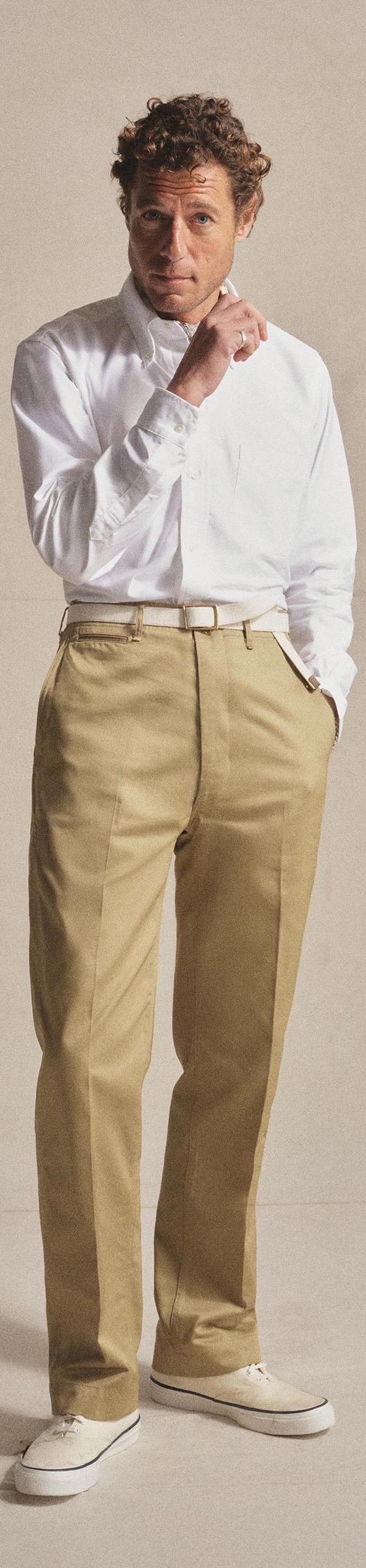 A man wearing a white long-sleeve shirt and khaki Anatomica chinos