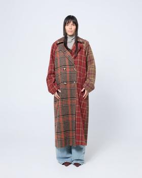 A woman wearing a red and brown patchwork checked Arthur Apparel coat with wide-leg jeans
