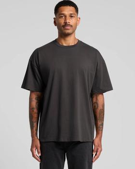 A man wearing a plain black AS Colour heavyweight crew-neck T-shirt with black jeans