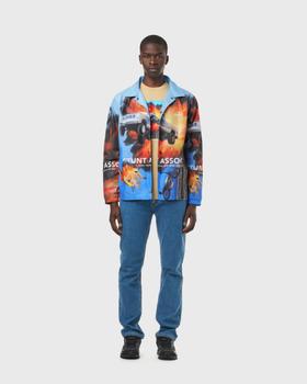 A man wearing a blue AVNIER Stunt Assoc. printed coach jacket