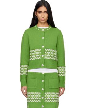 A woman wearing a green checkerboard-trimmed B.B. Wallace knit cardigan and matching skirt