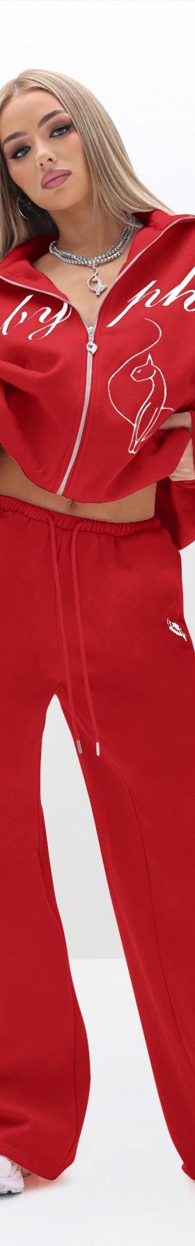 A woman wearing a red Baby Phat zip-up tracksuit with wide-leg sweatpants
