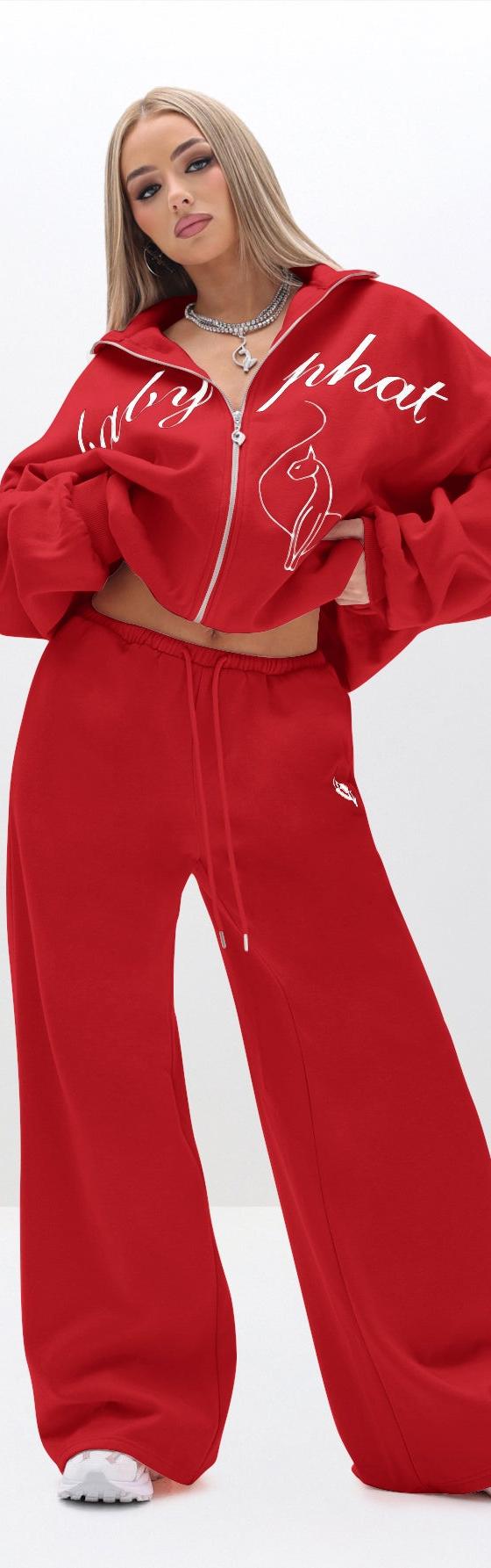 A woman wearing a red Baby Phat zip-up tracksuit with wide-leg sweatpants