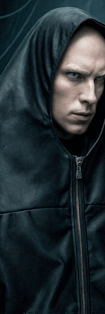 A man wearing a black oversized hooded BatNorton jacket