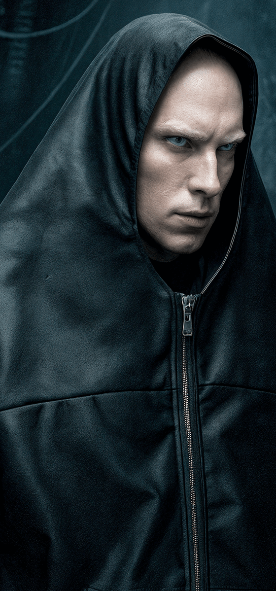 A man wearing a black oversized hooded BatNorton jacket