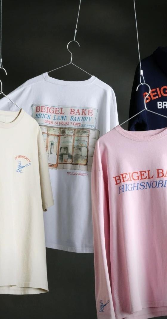 Beigel Bake x Highsnobiety tees, a long-sleeve and a Brick Lane hoodie hanging on wire hangers