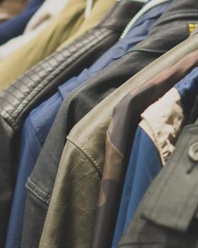 Close-up of a packed rack of vintage military and work jackets