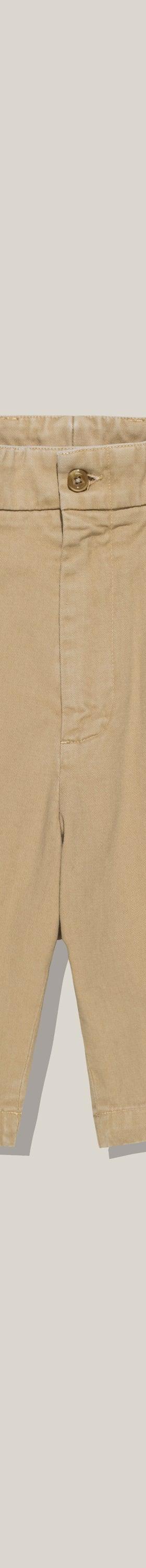 A pair of khaki Bills Khakis cotton twill shorts on a plain background